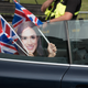 A woman wears a mask in Windsor, England, on May 18, 2018, ahead of the wedding of Prince Harry and Meghan Markle.